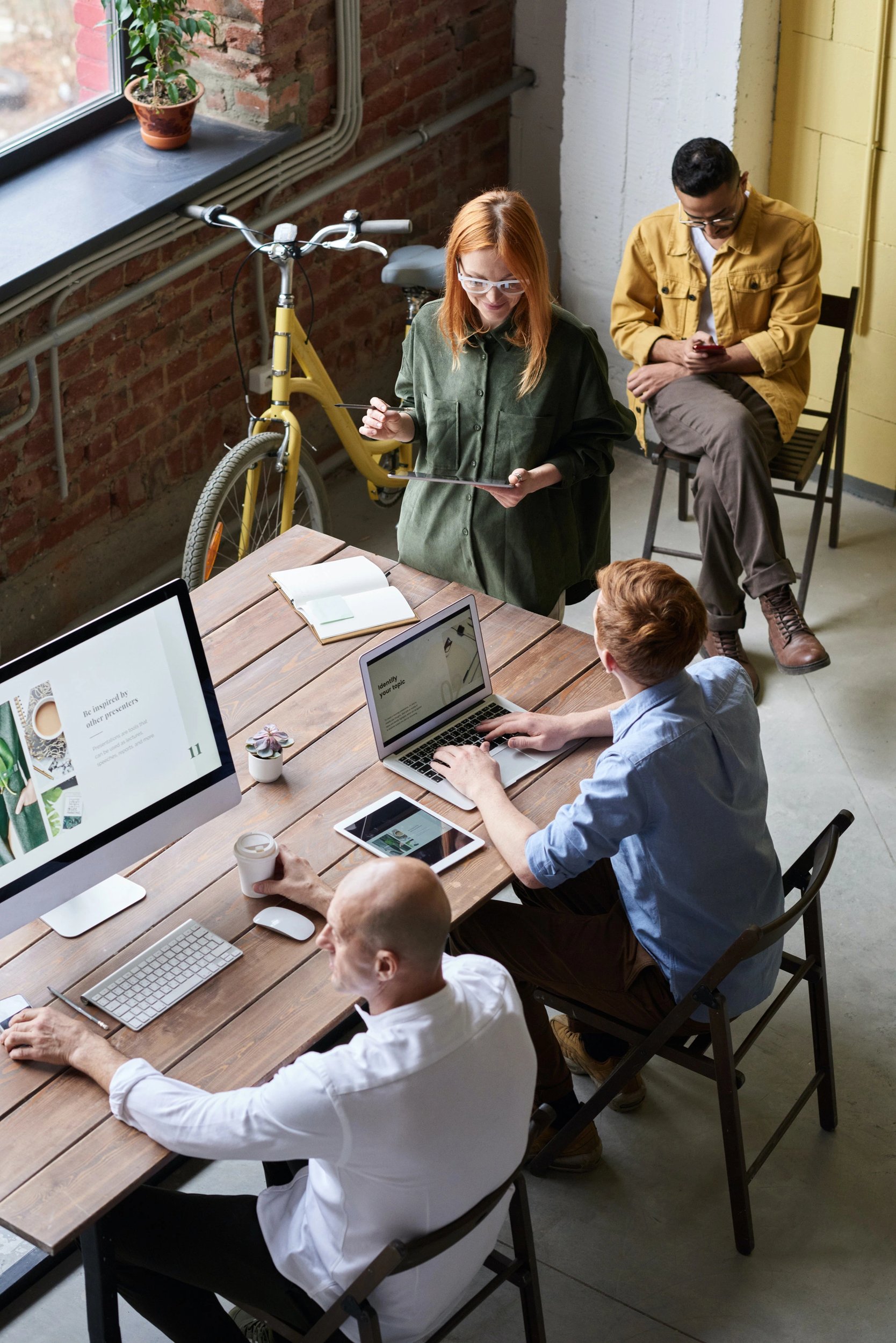 Four people at the meeting in the loft style office